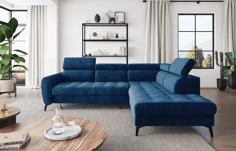 Modern Bjorn L corner sofa bed in blue velour fabric with adjustable headrests and high metal legs, placed in a stylish living room.